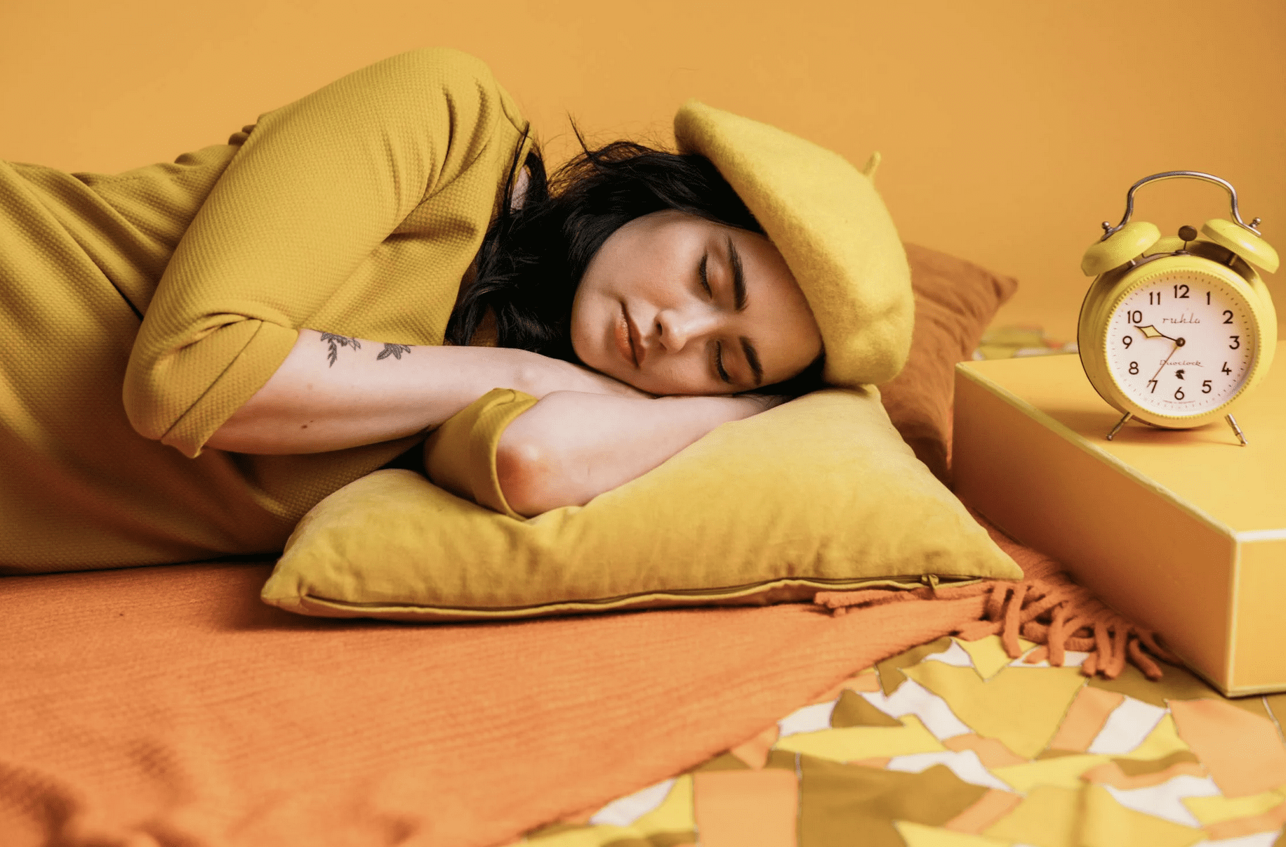 Woman sleeping by alarm clock to manage stress