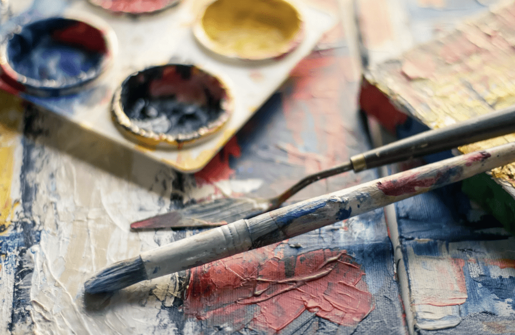 Photo of paint brushes and paint to symbolize the use of hobbies to manage stress